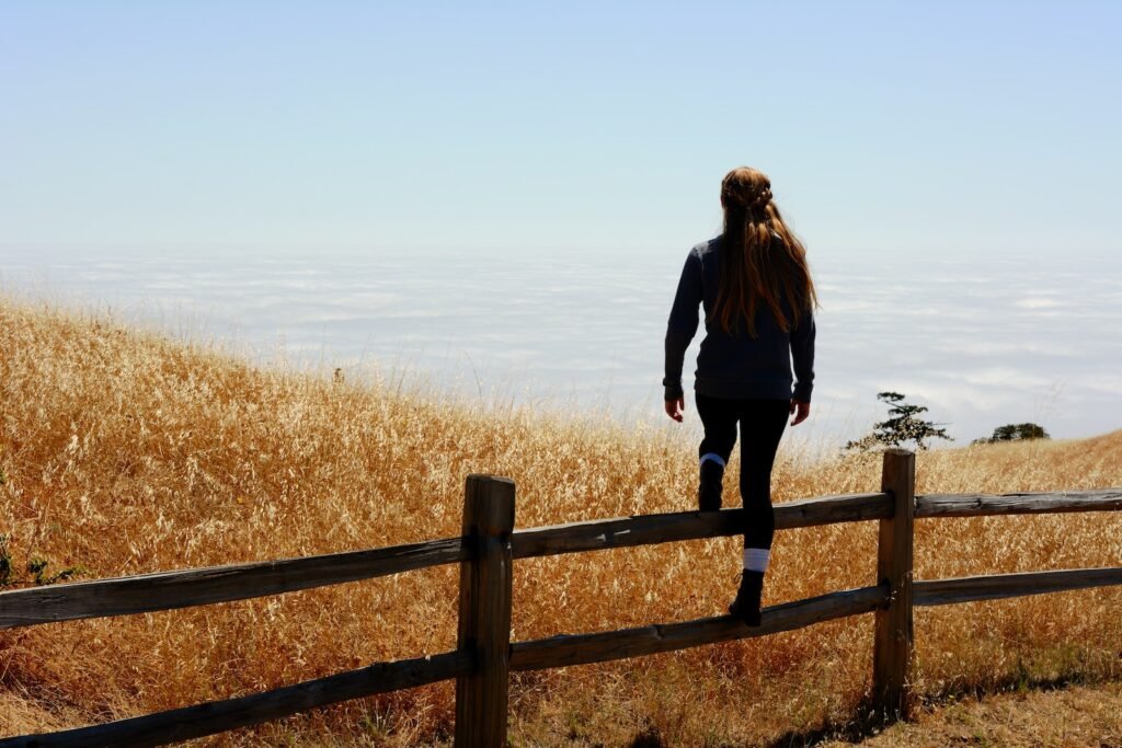 woman jump on brown fence