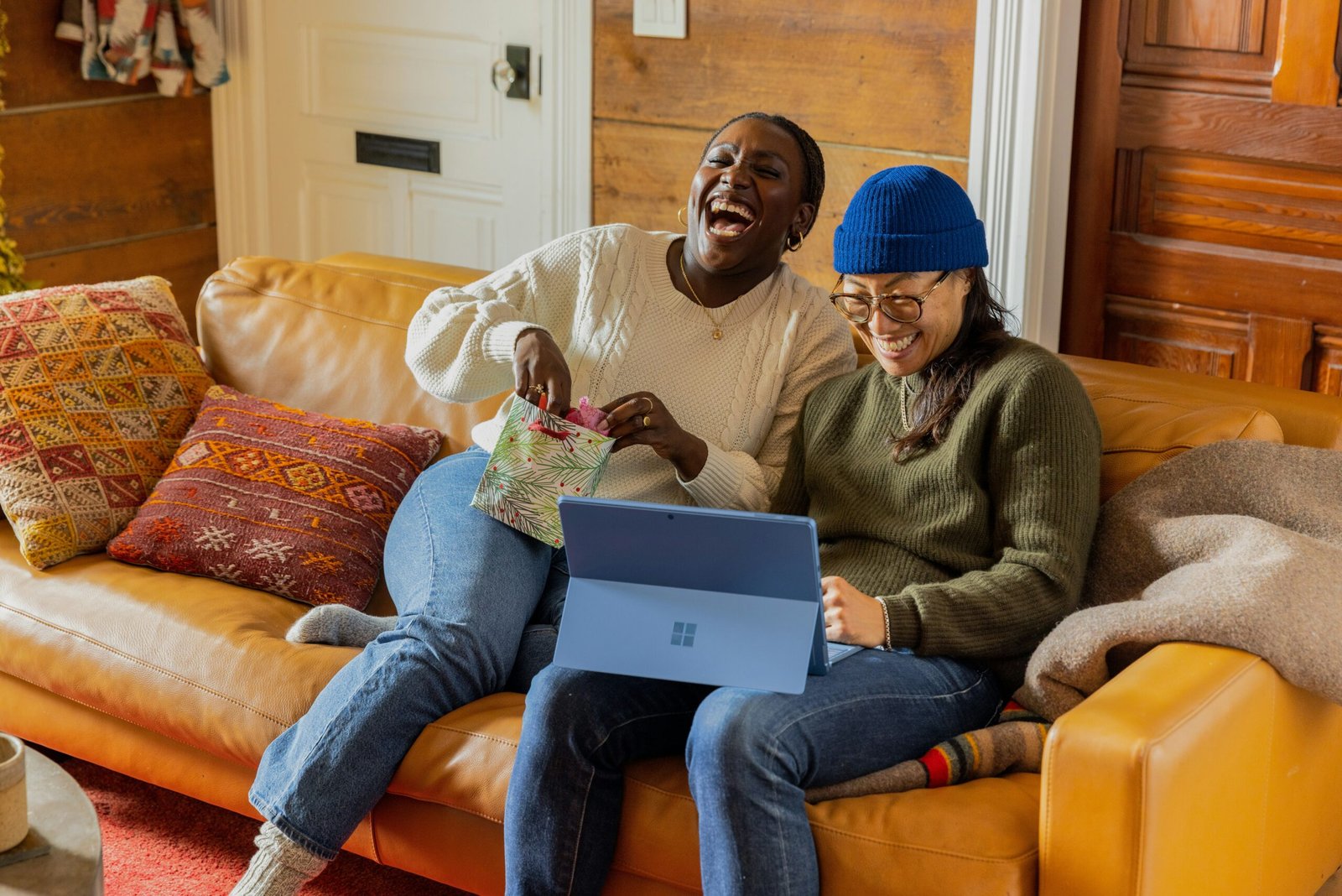 a person sitting on a couch with a laptop