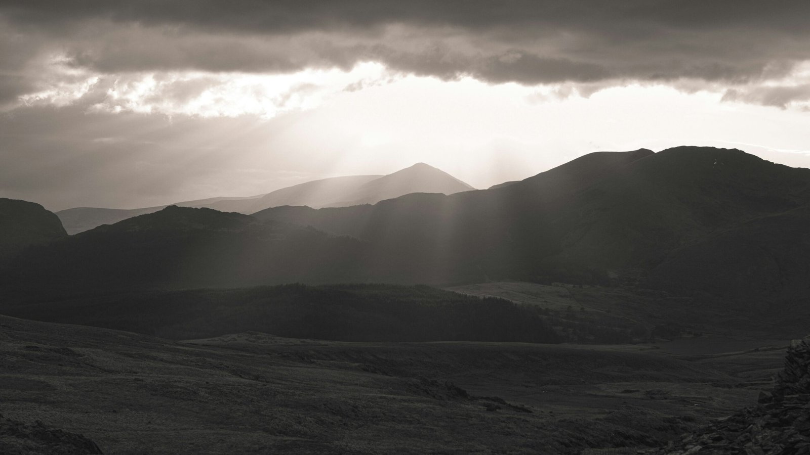 silhouette of mountains under cloudy sky during daytime